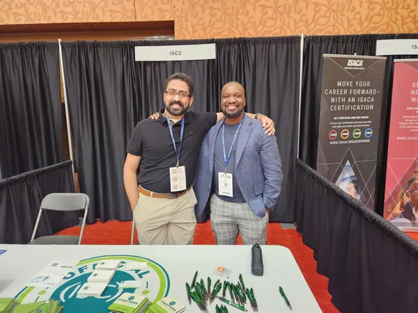 Two chapter members standing at a conference exhibit booth