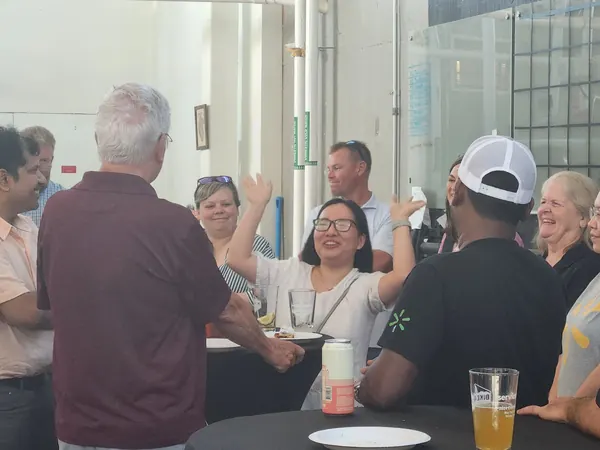 Members laughing together at a table